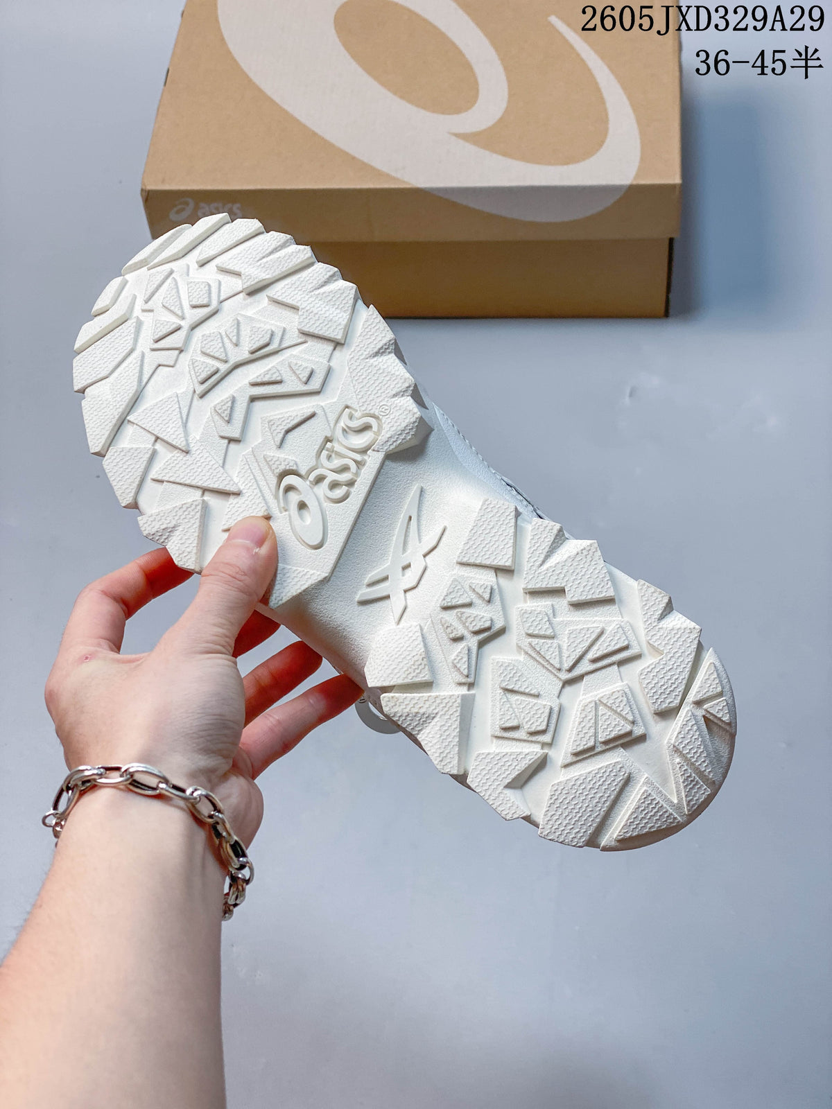 Close-up of the sneaker's white outsole with angular tread pattern.