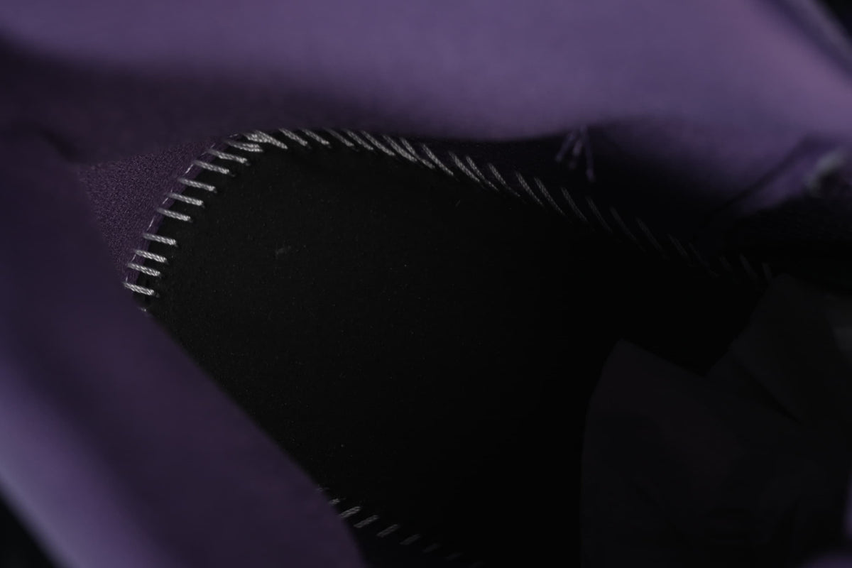 Close-up of the interior stitching and dark lining.
