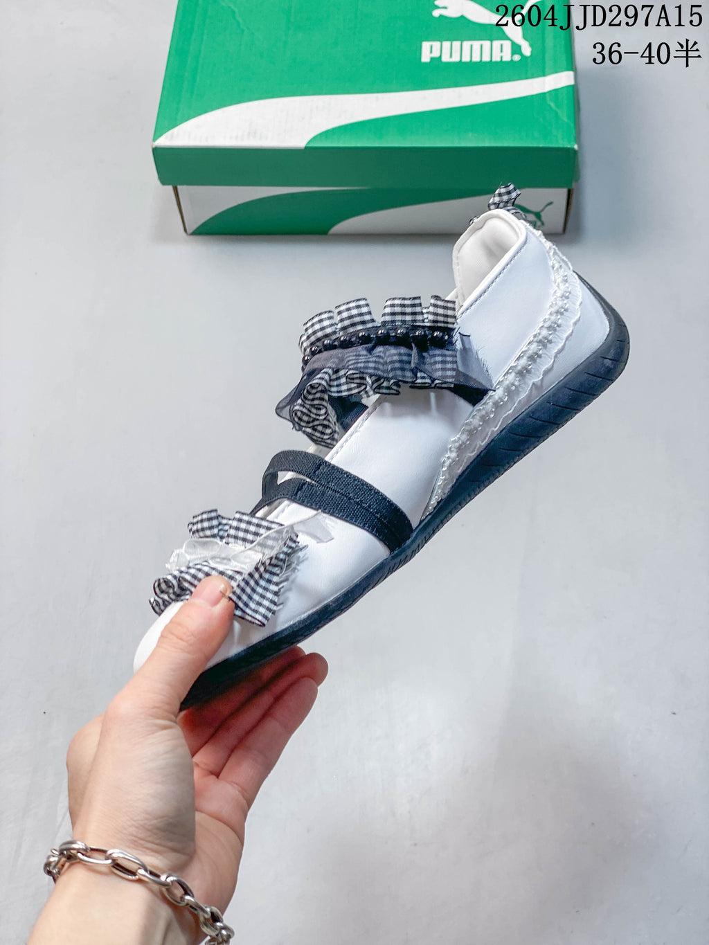 Side view of a white flat with dark straps, gingham ruffles and a low-profile outsole.