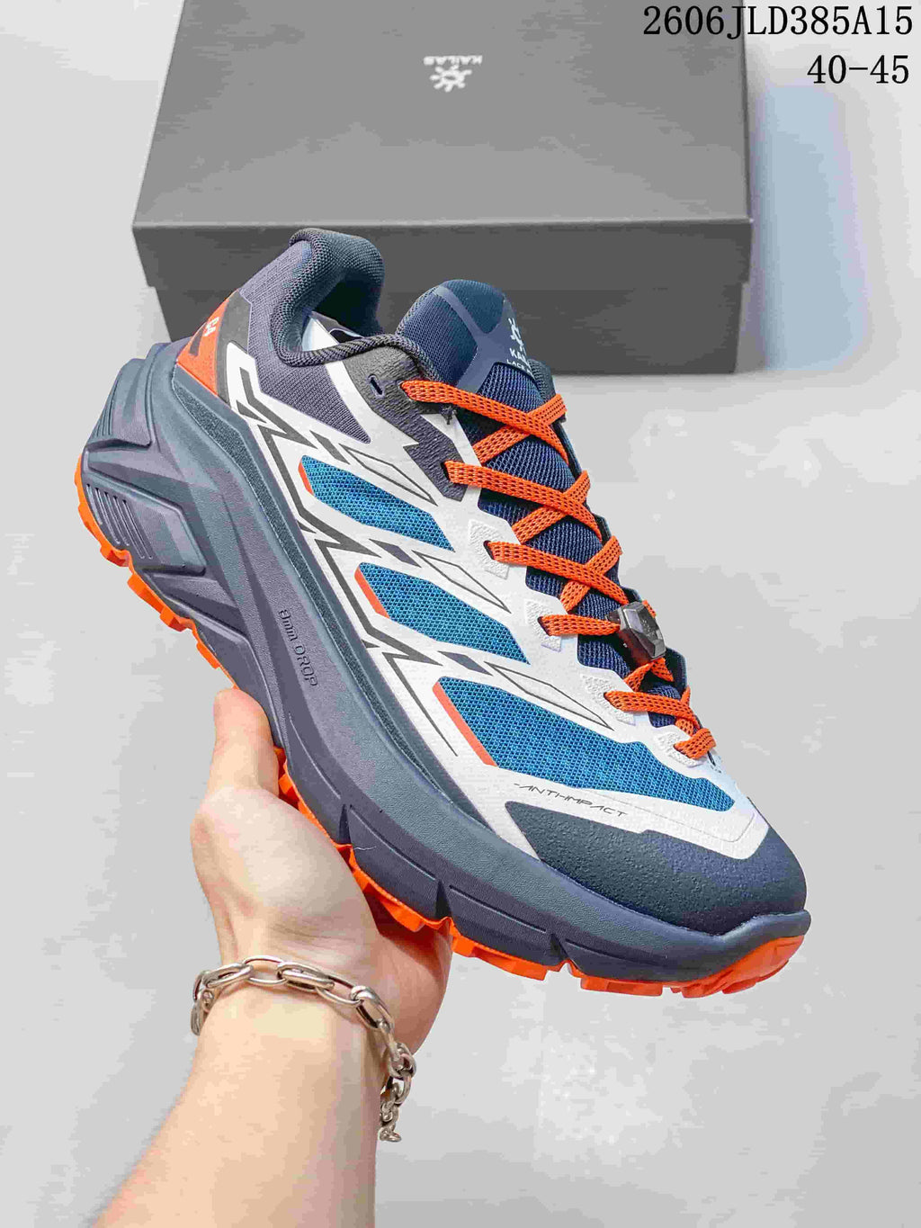 Navy and gray Kailas C4 trail shoe with bright orange laces and outsole accents.