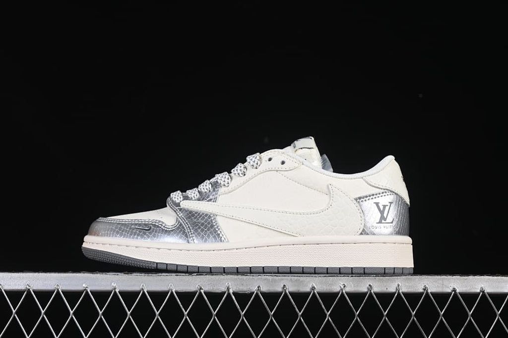 Side view of a silver and white low-top sneaker with patterned overlays.