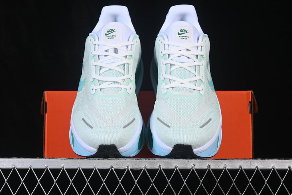 Front view of pale mint Nike Vomero Premium shoes with white laces and light blue accents