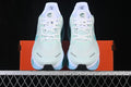 Front view of pale mint Nike Vomero Premium shoes with white laces and light blue accents