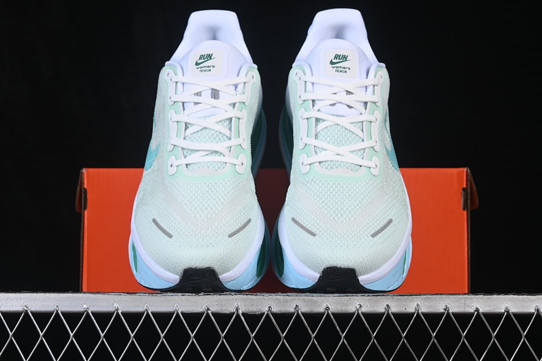 Front view of pale mint Nike Vomero Premium shoes with white laces and light blue accents