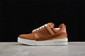 Side view of a brown LV Trainer sneaker with white laces and a white sole