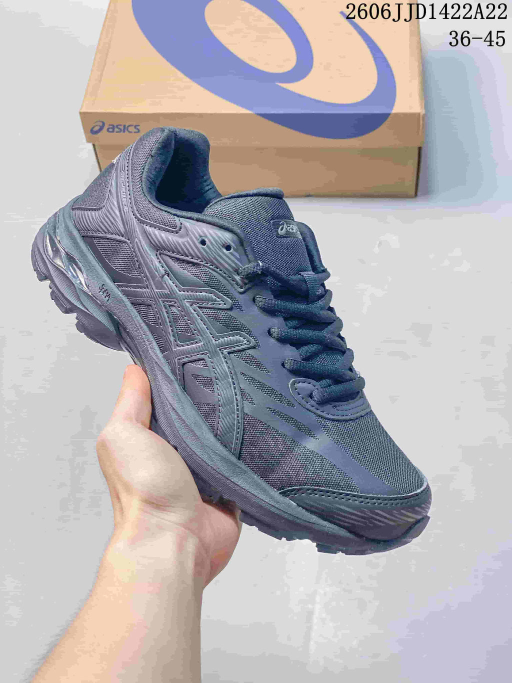 Dark gray ASICS GEL-FLUX shoe with mesh panels and a sculpted sole.