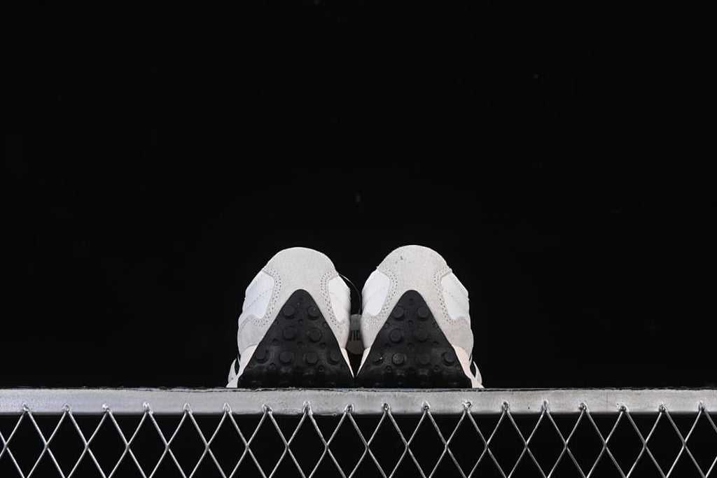 Rear view of both sneakers showing the heel and outsole details.