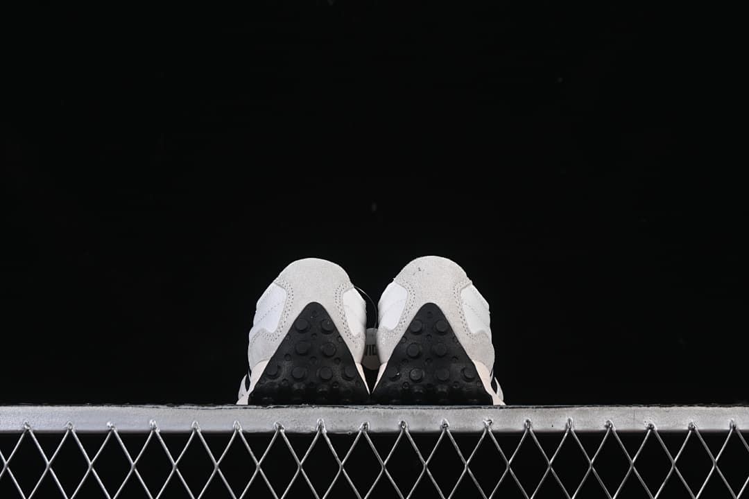 Rear view of both sneakers showing the heel and outsole details.