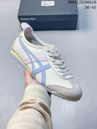 White Mexico 66 sneaker with light blue side stripes and pink accents, shown with a branded shoe box.