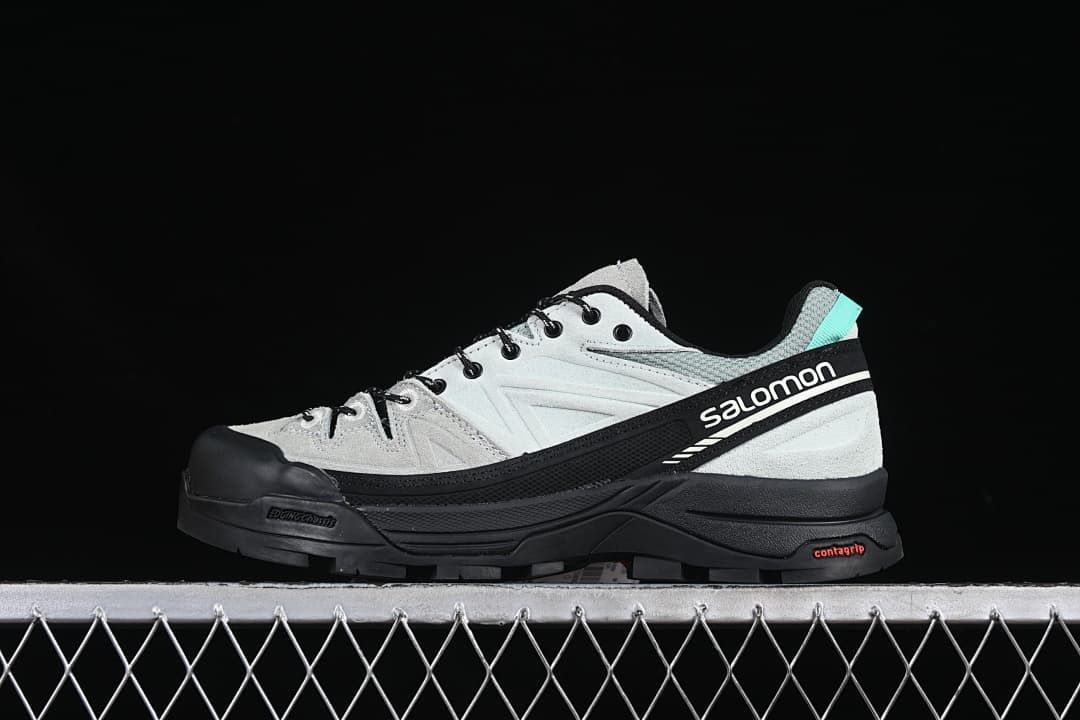 Side view of the shoe showing Salomon branding and turquoise heel detail.