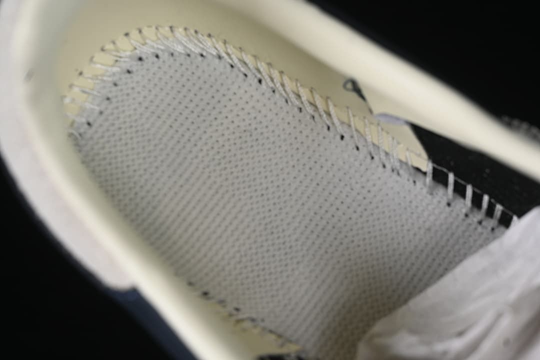 Close-up view inside the sneaker, showing the insole and stitching