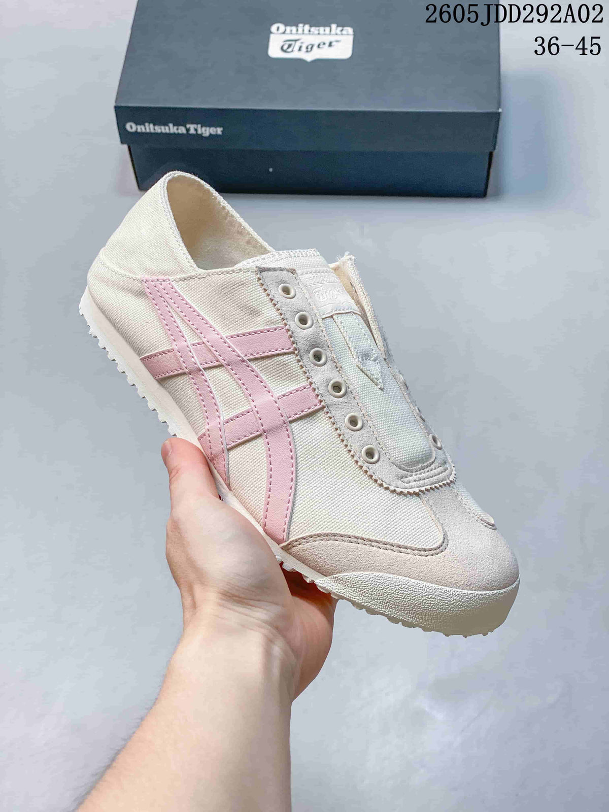 Off-white slip-on sneaker with pink side stripes and metal eyelets