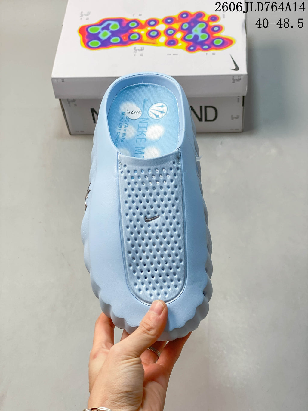 Top view of the perforated footbed and upper of the light blue mule