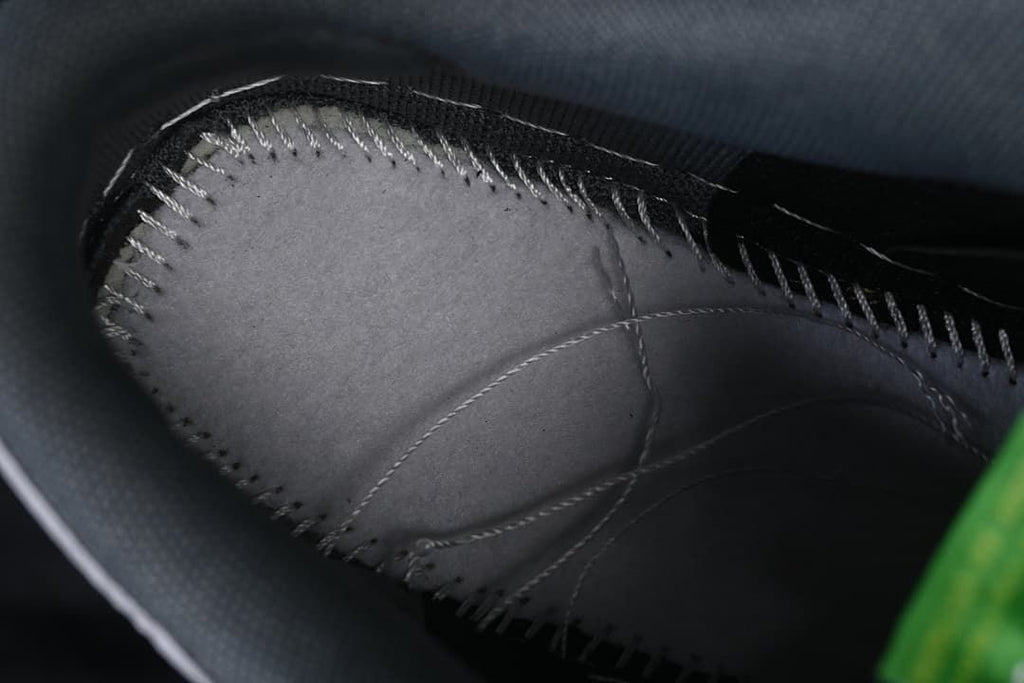 Close-up of interior stitching and gray lining.