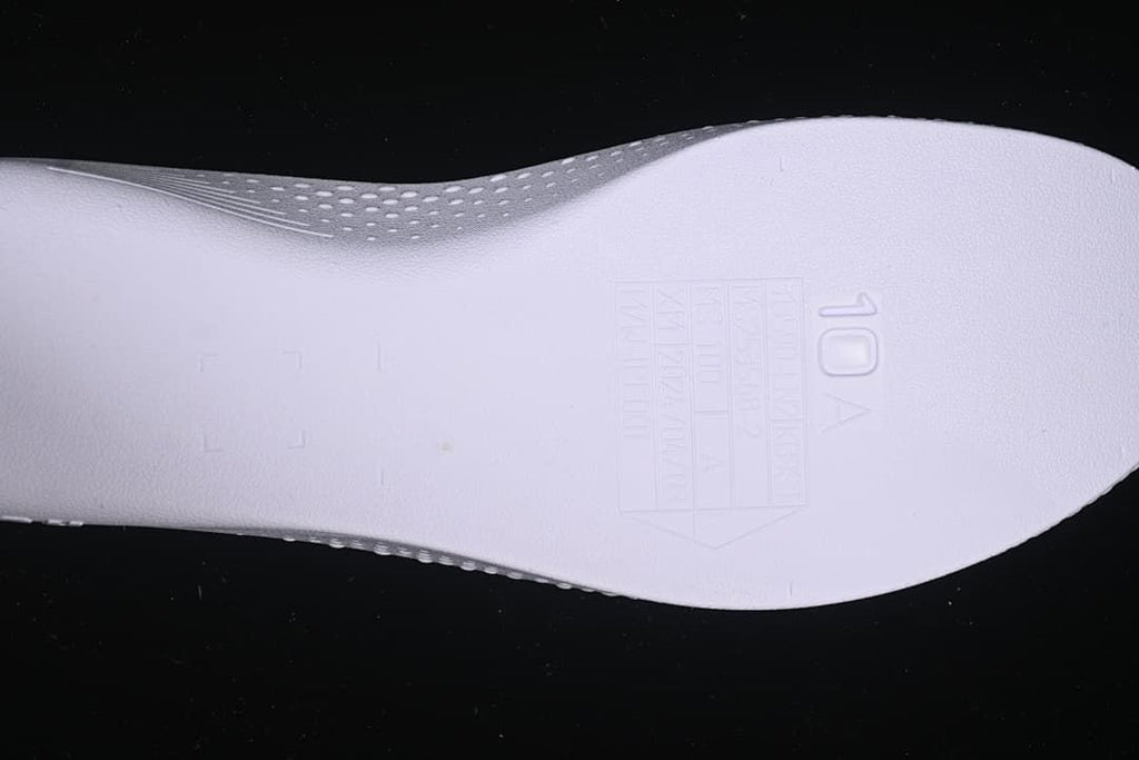 Close-up of a shoe component with a visible size marking