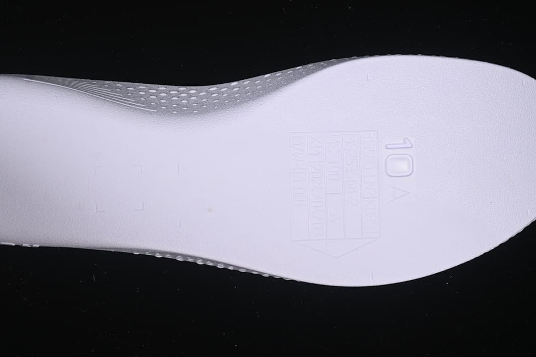 Close-up of a shoe component with a visible size marking