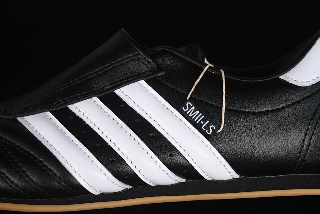 Close-up of the white side stripes, black upper, and attached tag.
