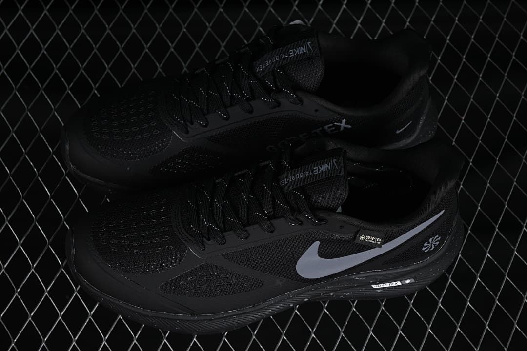 Pair of black Nike running shoes with gray Swooshes, shown from above and the side.