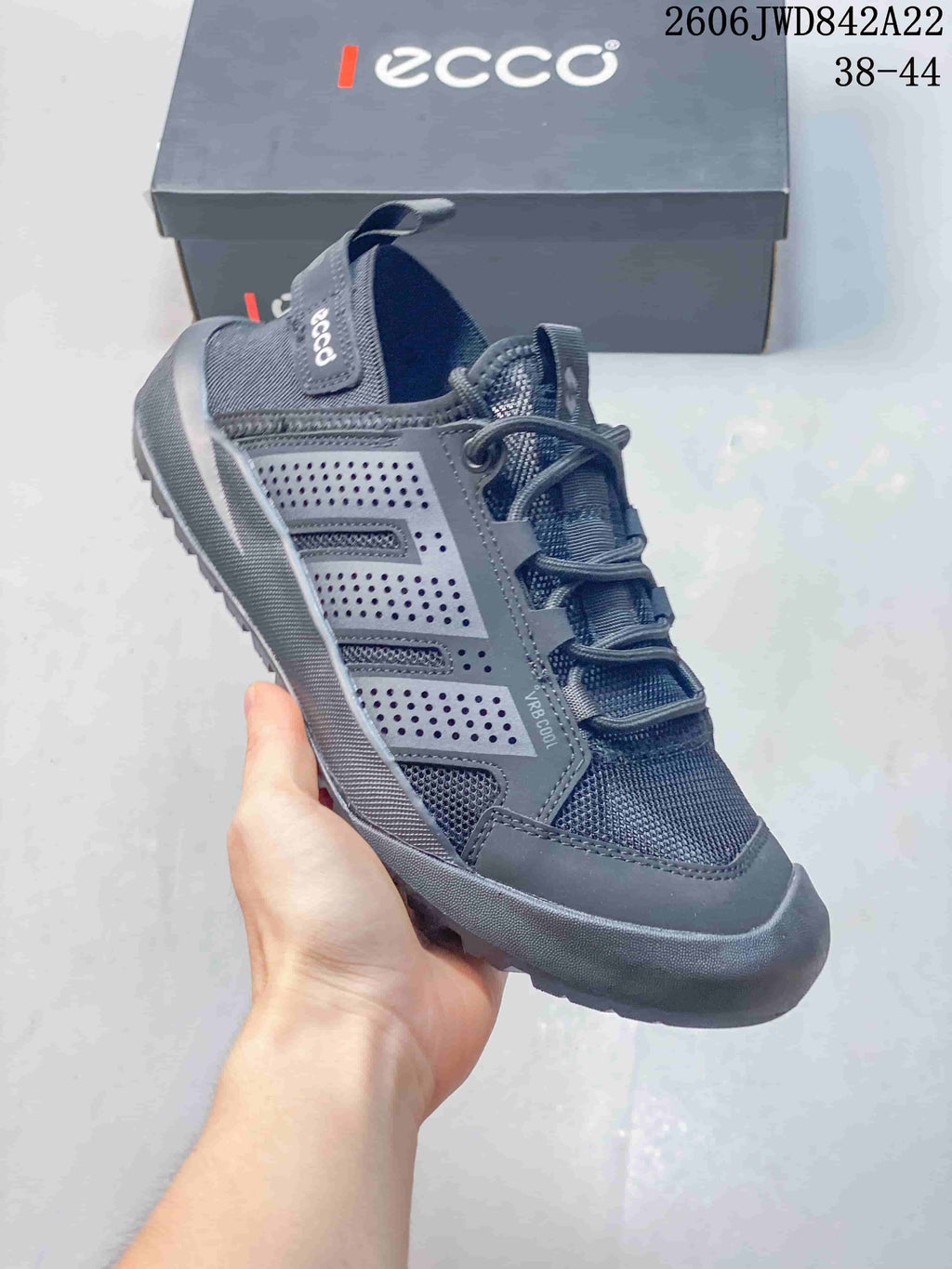 Angled side view of a gray ECCO sneaker with perforated panels