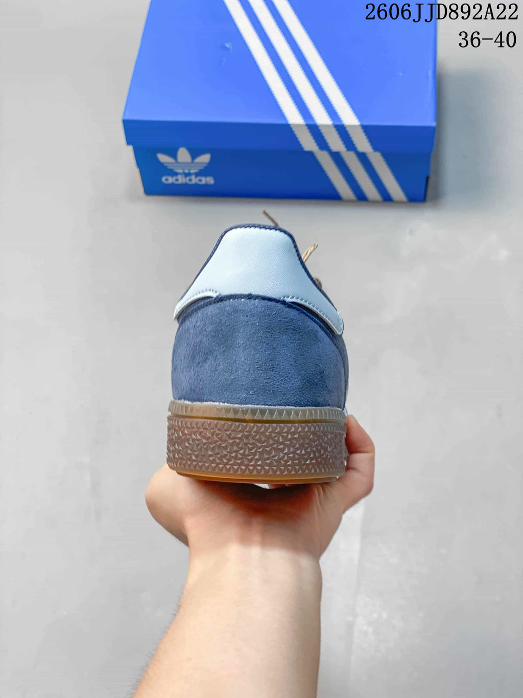 Rear view of a blue low-top sneaker with a light-colored heel detail