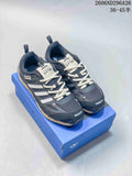 Pair of dark gray Adidas Originals PR SFTM low-top sneakers with light laces on a blue box
