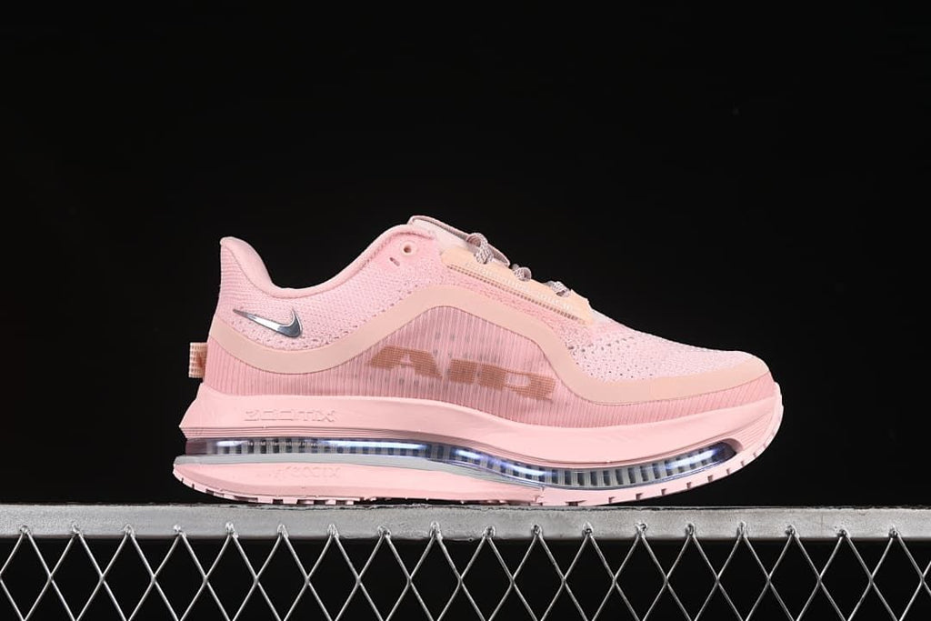 Side profile of the pink shoe showing its layered upper and visible midsole unit