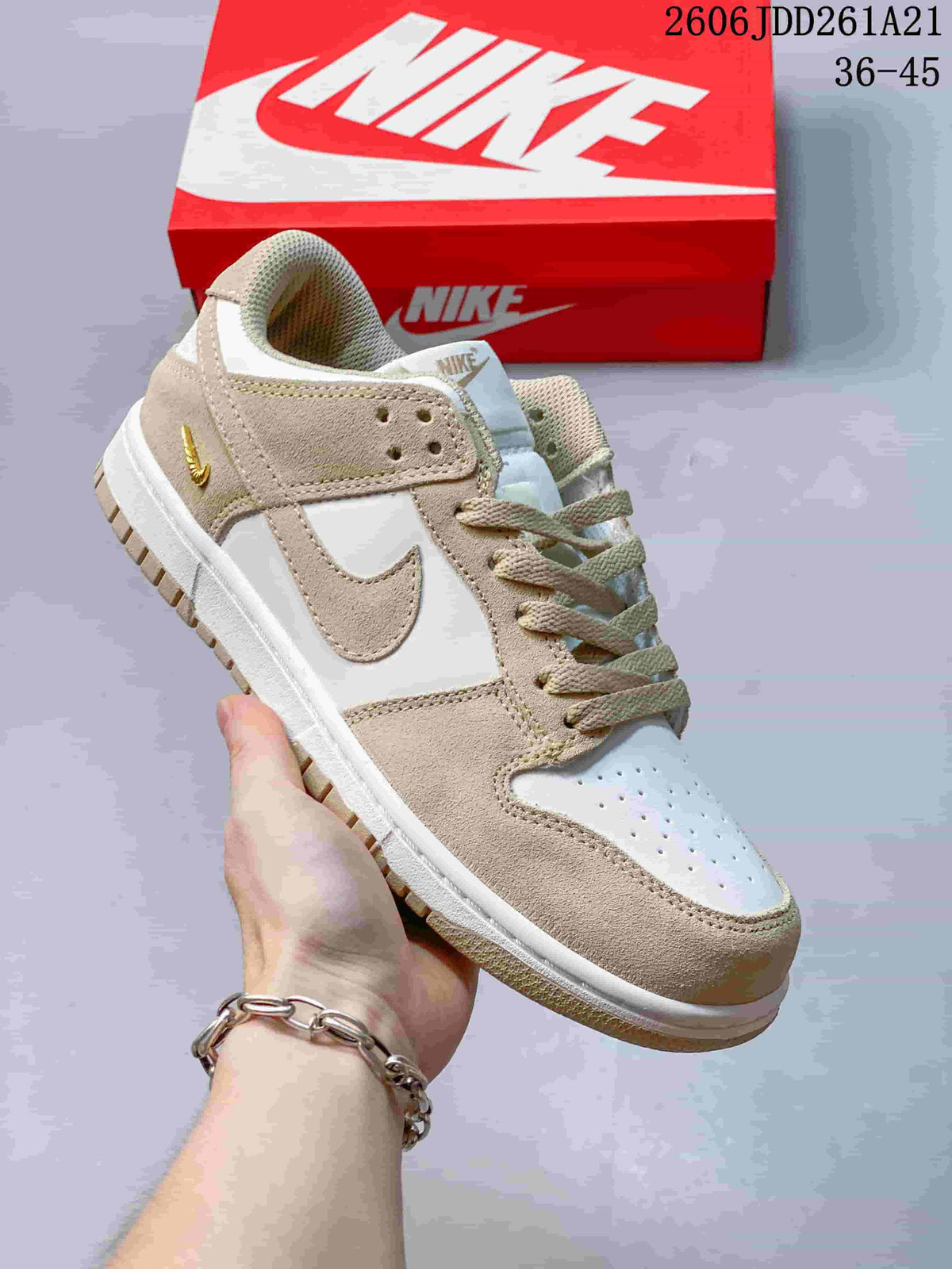 Beige and white low-top Nike Dunk sneaker with light neutral accents