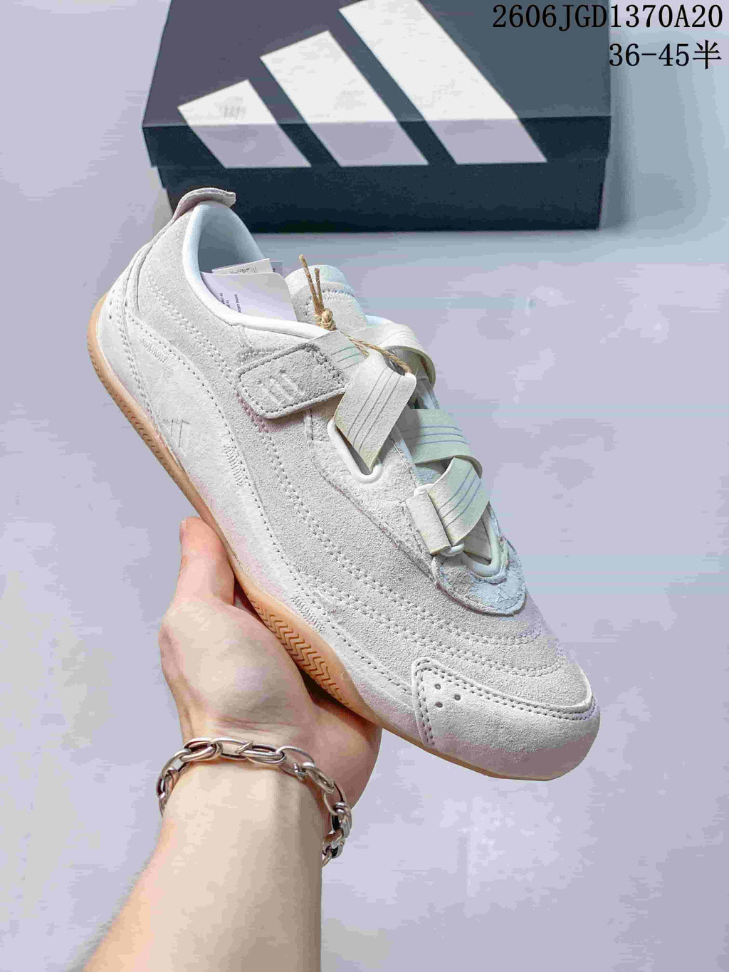 Angled side view of the shoe showing its textured upper and strap closure