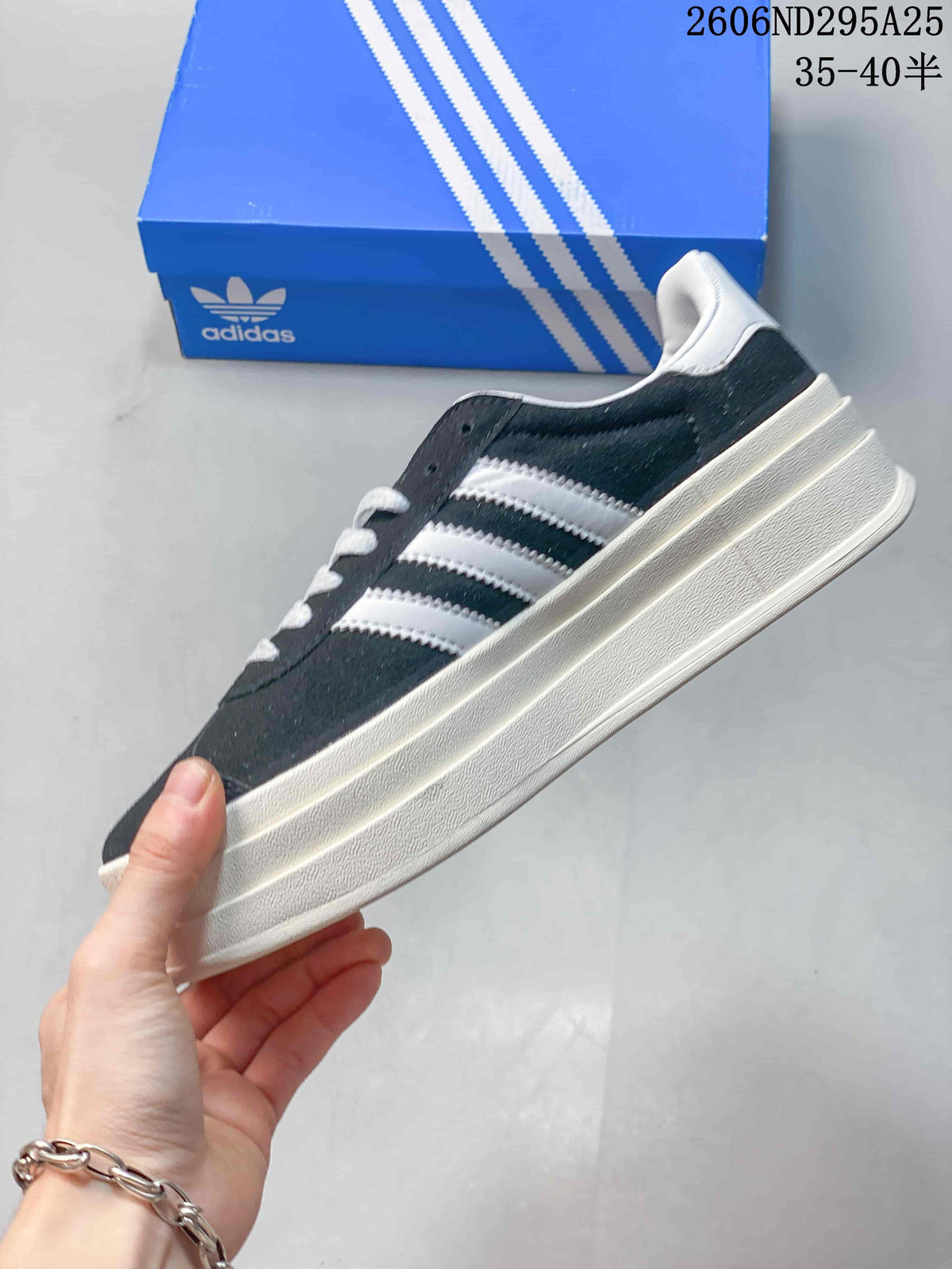 Side profile of the dark blue Adidas Gazelle Bold W with white stripes and a raised off-white sole.