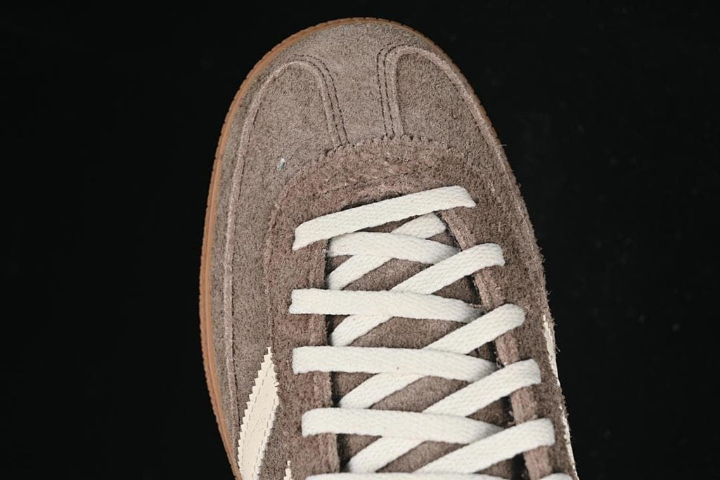 Top view of the brown sneaker toe and white laces.