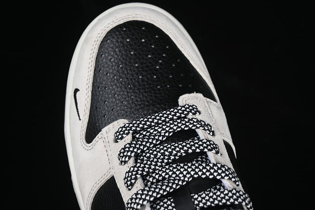Top-front view of the black toe panel and patterned laces