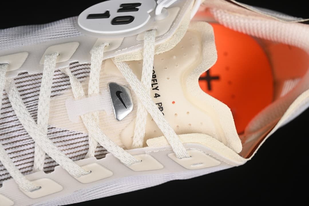 Close-up of the shoe tongue, laces, and orange insole