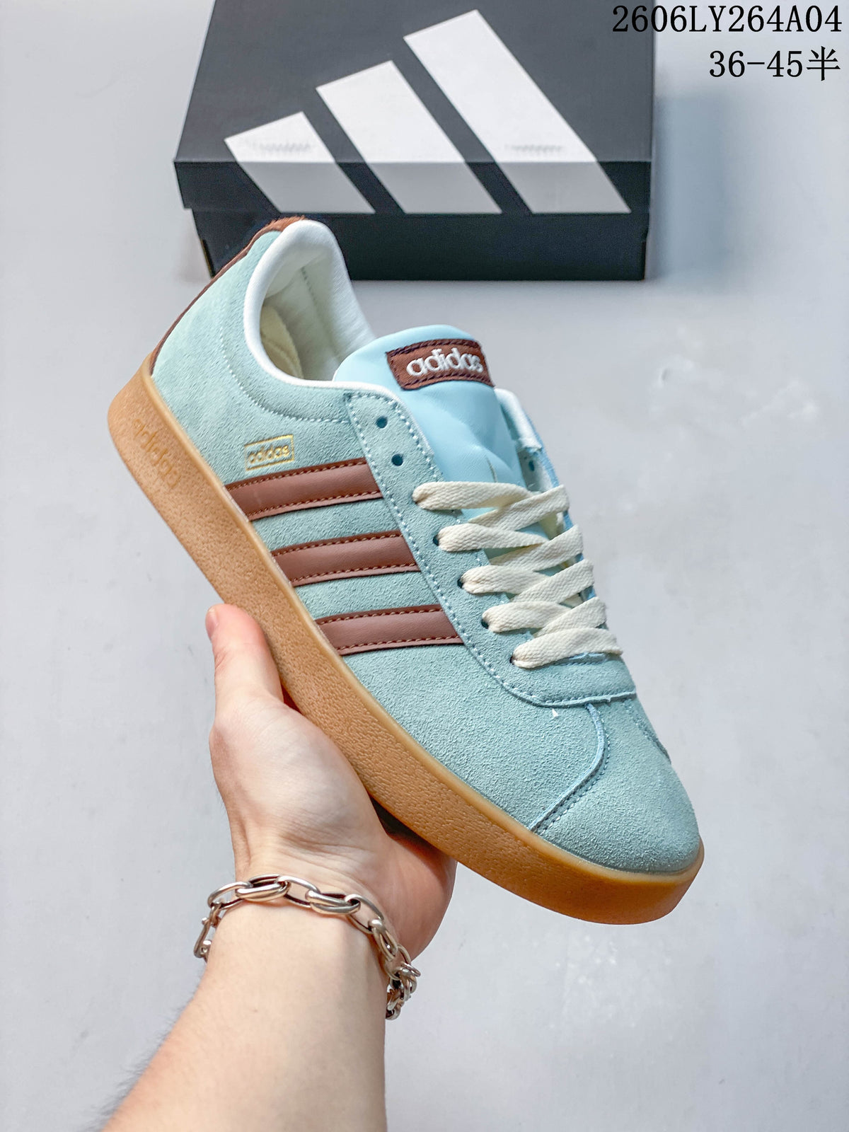 Angled view of the blue sneaker with brown stripes, cream laces, and gum-colored sole