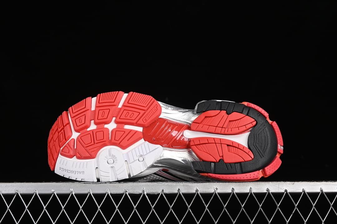 Underside view showing the segmented red, white and black outsole.