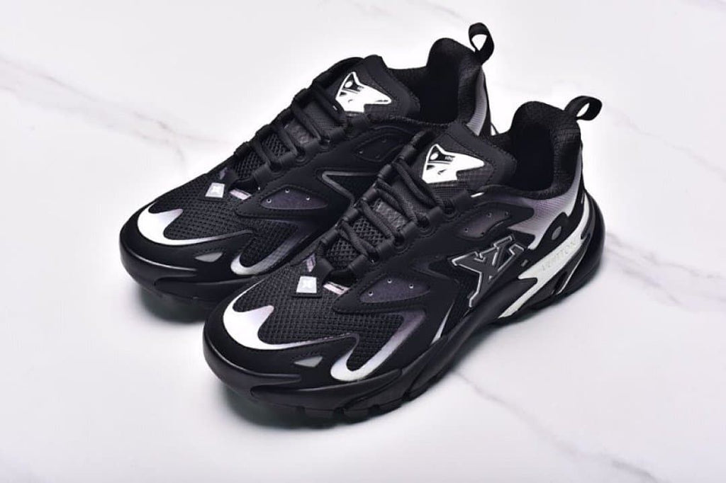 Angled view of a pair of black and white Runner Tatic sneakers