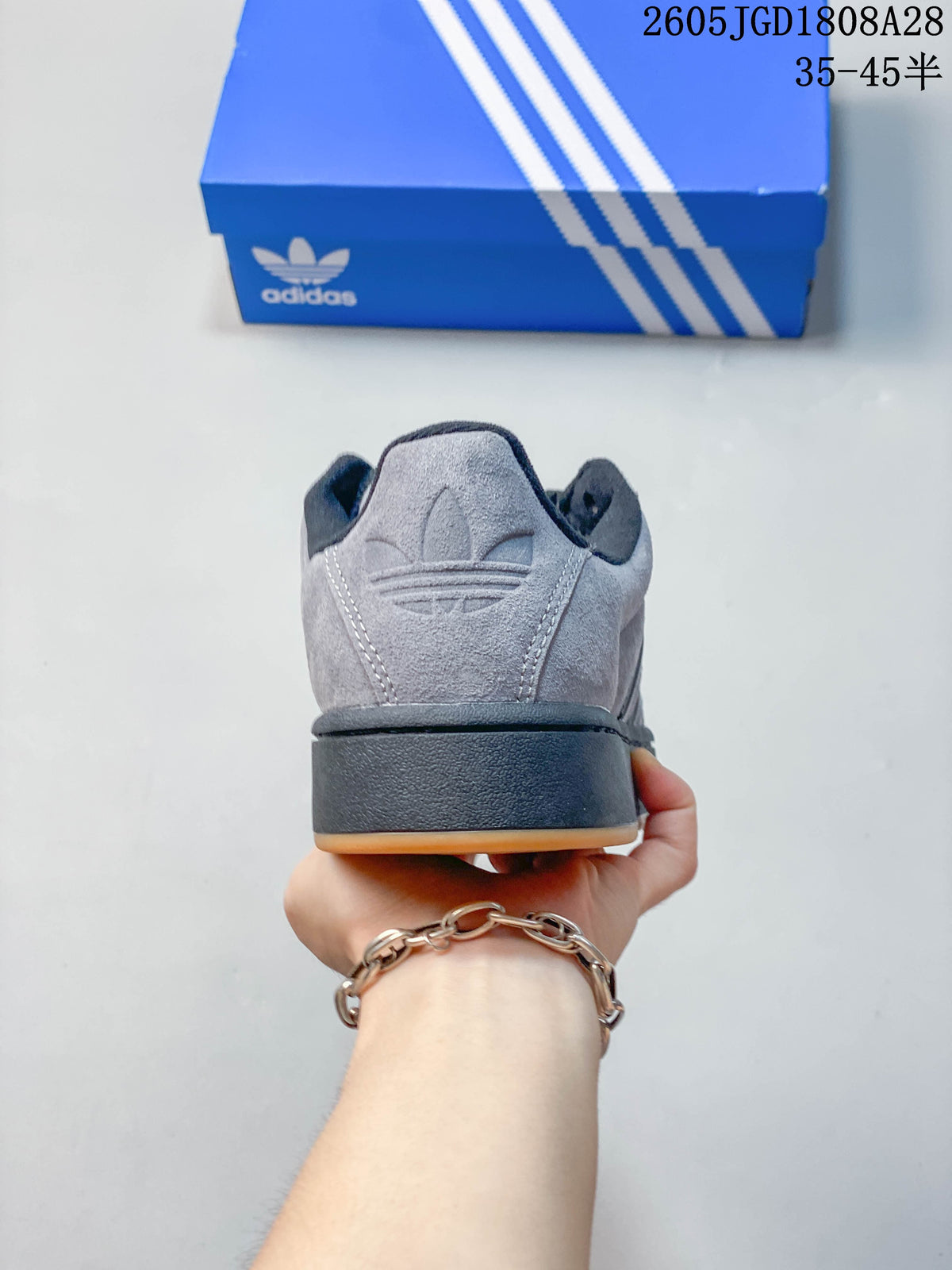 Rear view showing the grey heel, dark midsole and gum outsole.