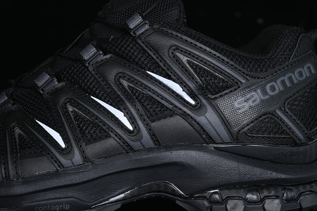Close-up of the black upper, side overlays, and Salomon branding