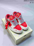 Pair of red and white low-top Jordan sneakers with patterned laces and a dangling charm