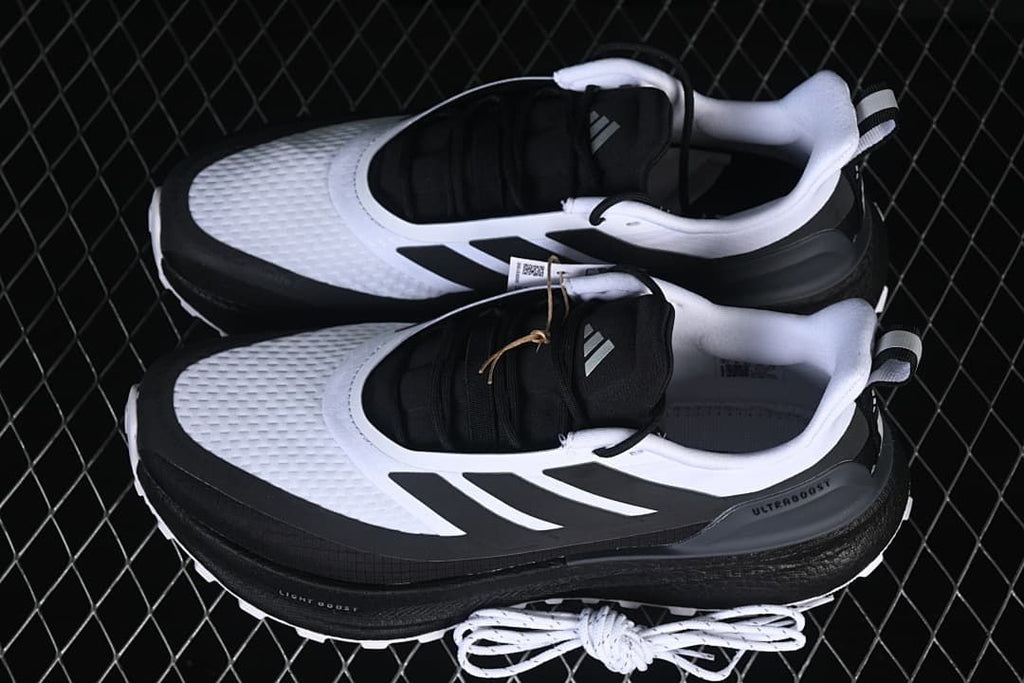 Pair of white and black shoes shown from above