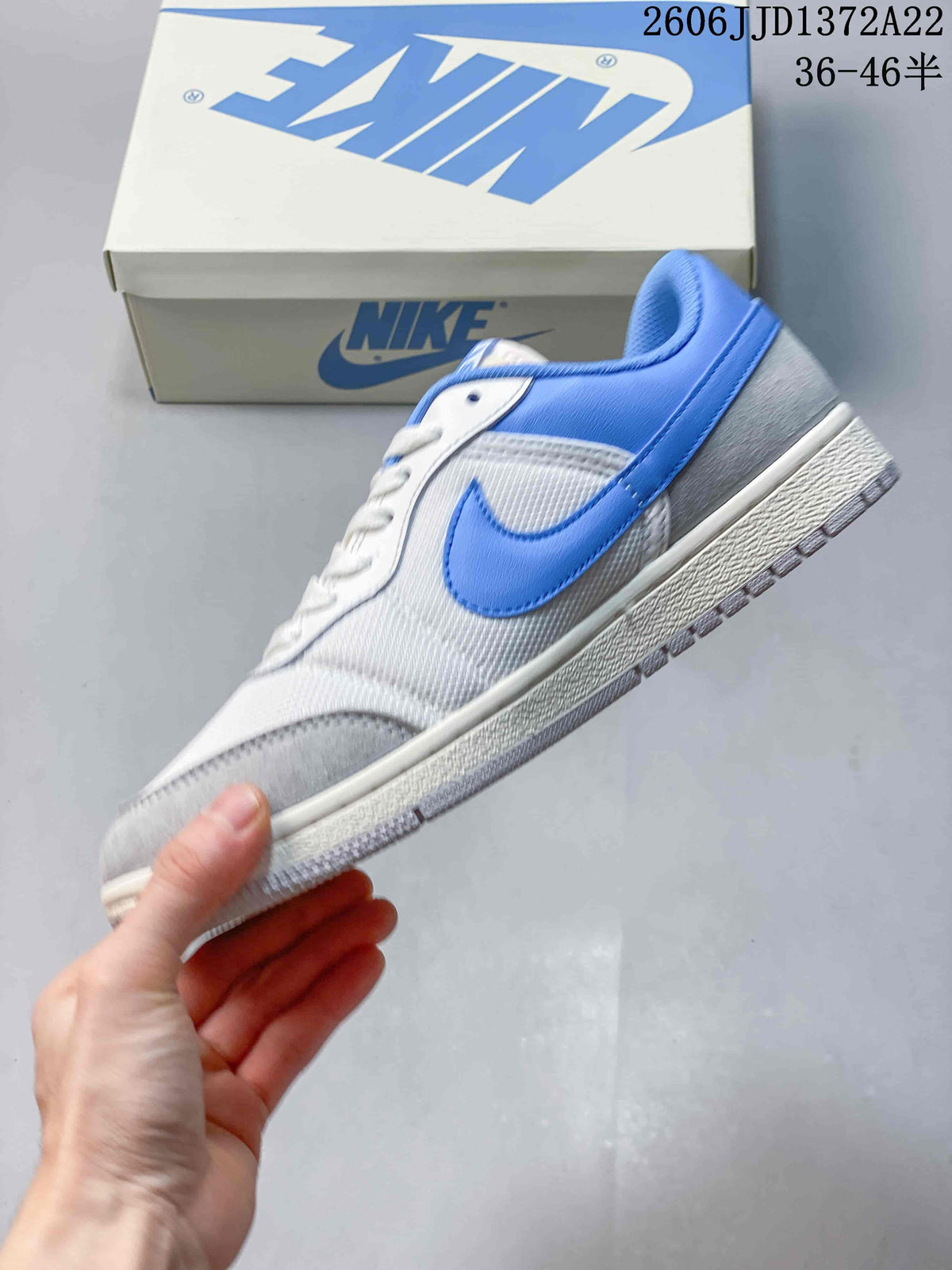 Side view of the white, blue, and gray low-top sneaker