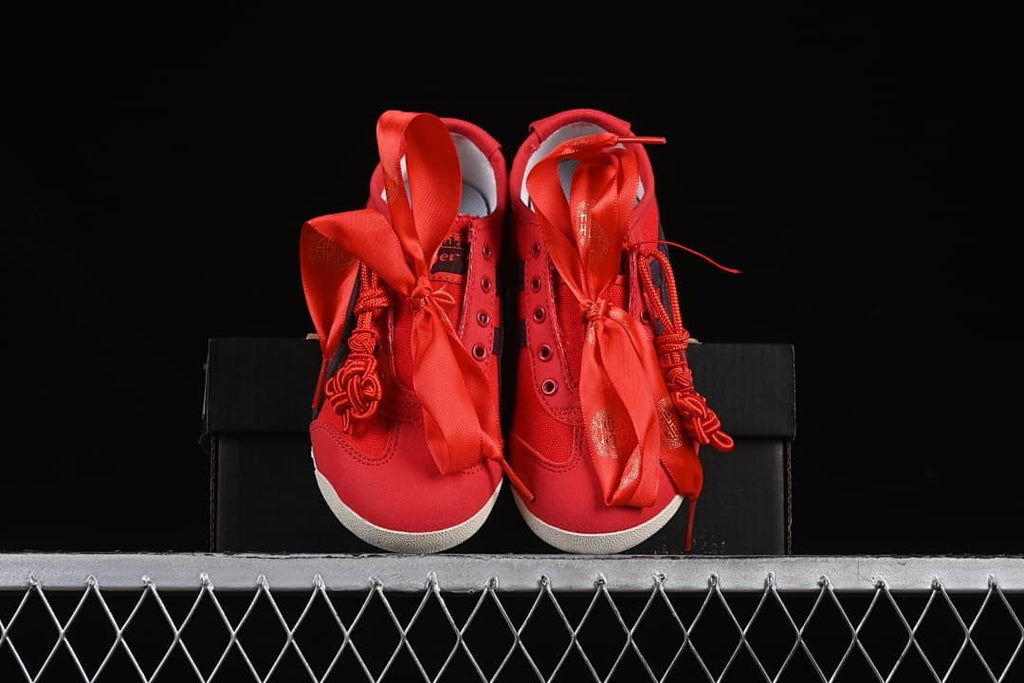Front view of the pair of red sneakers with wide ribbon laces