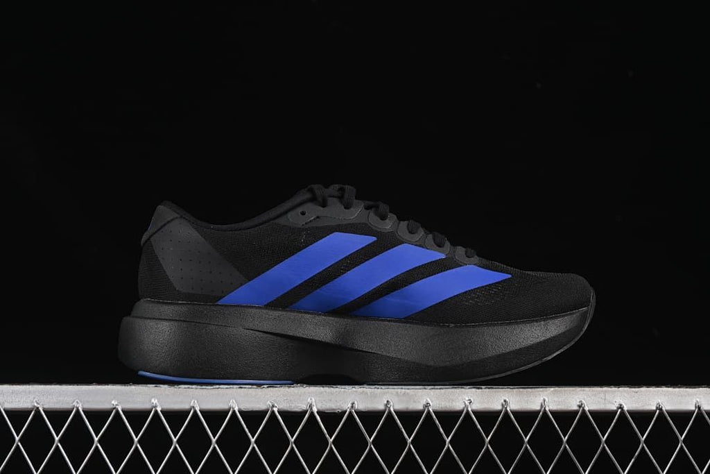 Side profile of the black shoe with blue stripes and sculpted midsole.