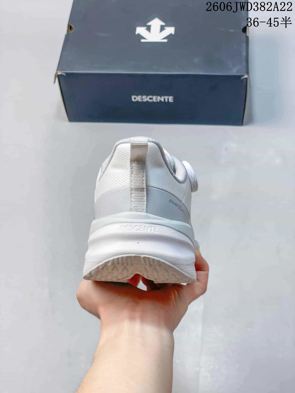 Rear view of the white DESCENTE running shoe and thick midsole.