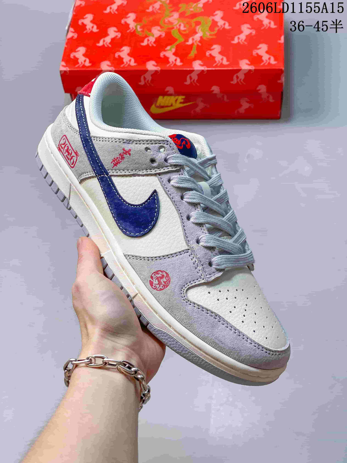 Angled view of the sneaker showing navy and red accents with grey overlays