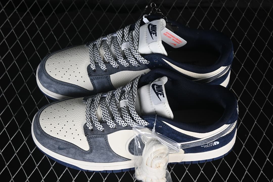 Pair of gray, off-white, and navy low-top sneakers shown from above with patterned laces
