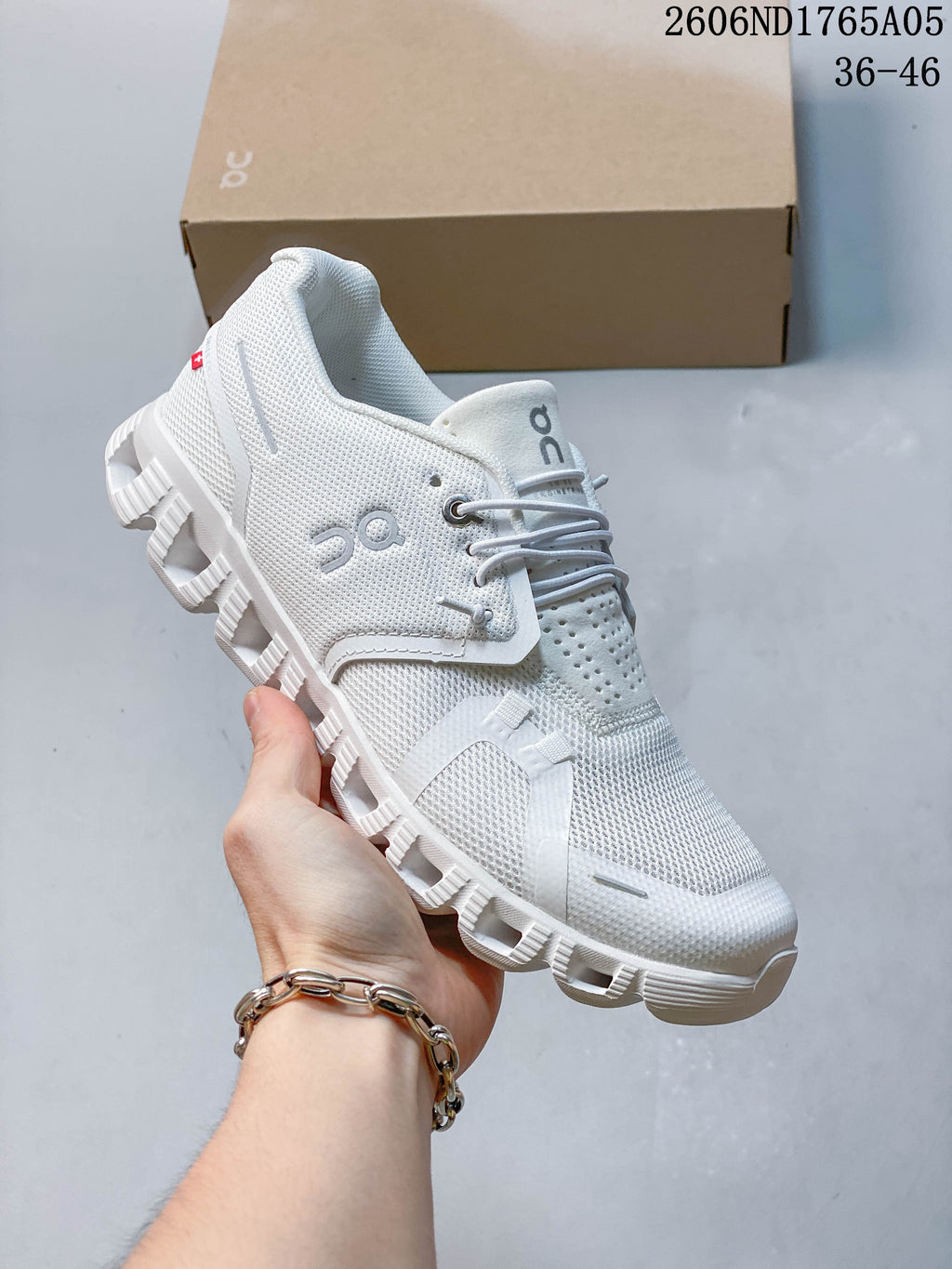 Angled side view of a white On Cloud 5 sneaker