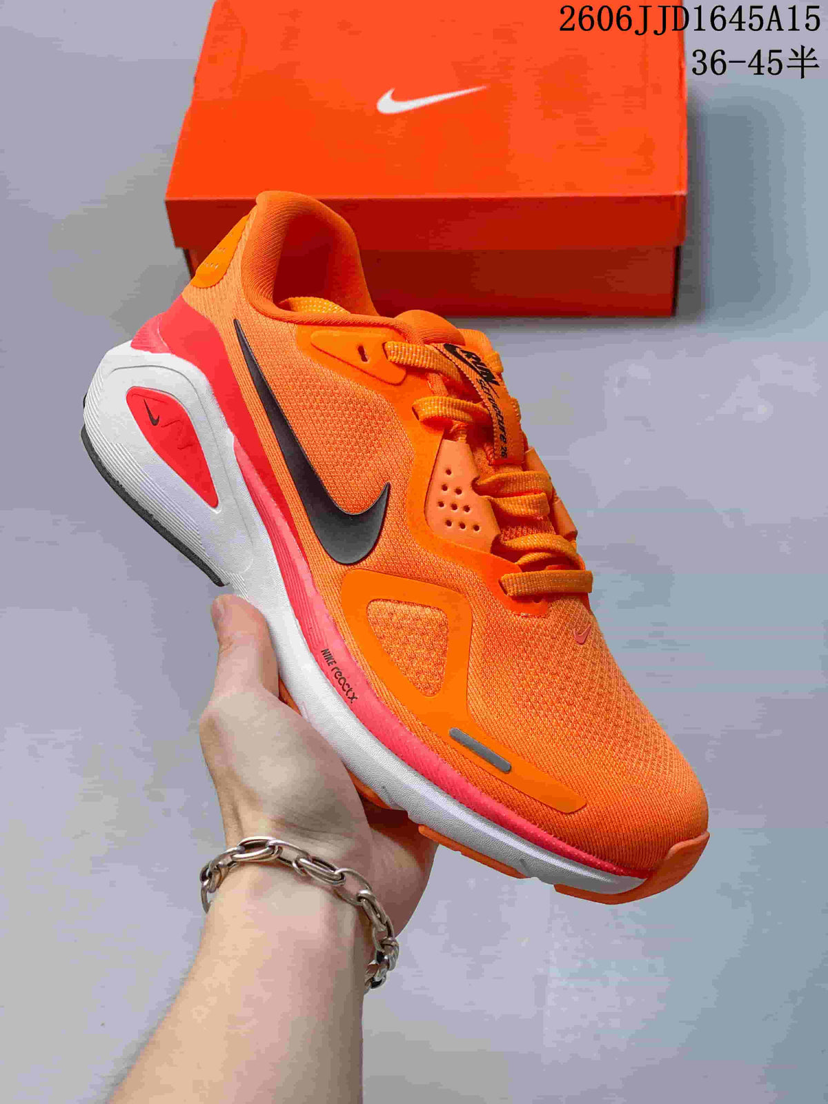 Orange Nike Air Structure 26 running shoe with coral accents and a dark Swoosh.