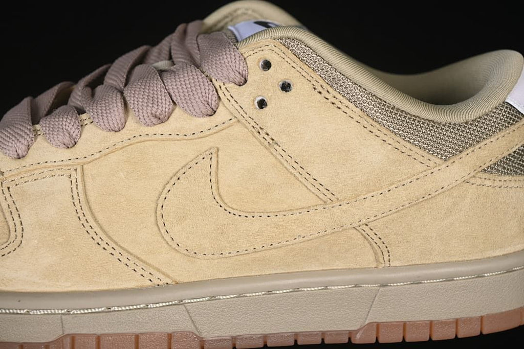 Close-up of the tan side panel, Swoosh, and mauve-toned laces