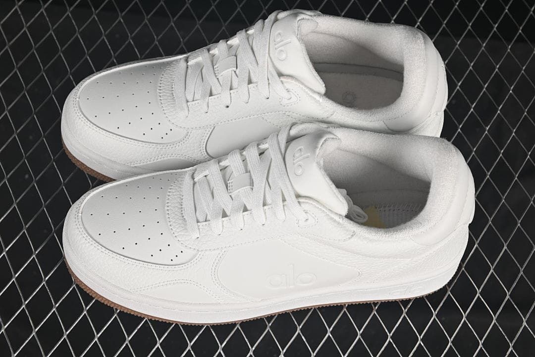 Pair of white low-top sneakers shown from above at an angle