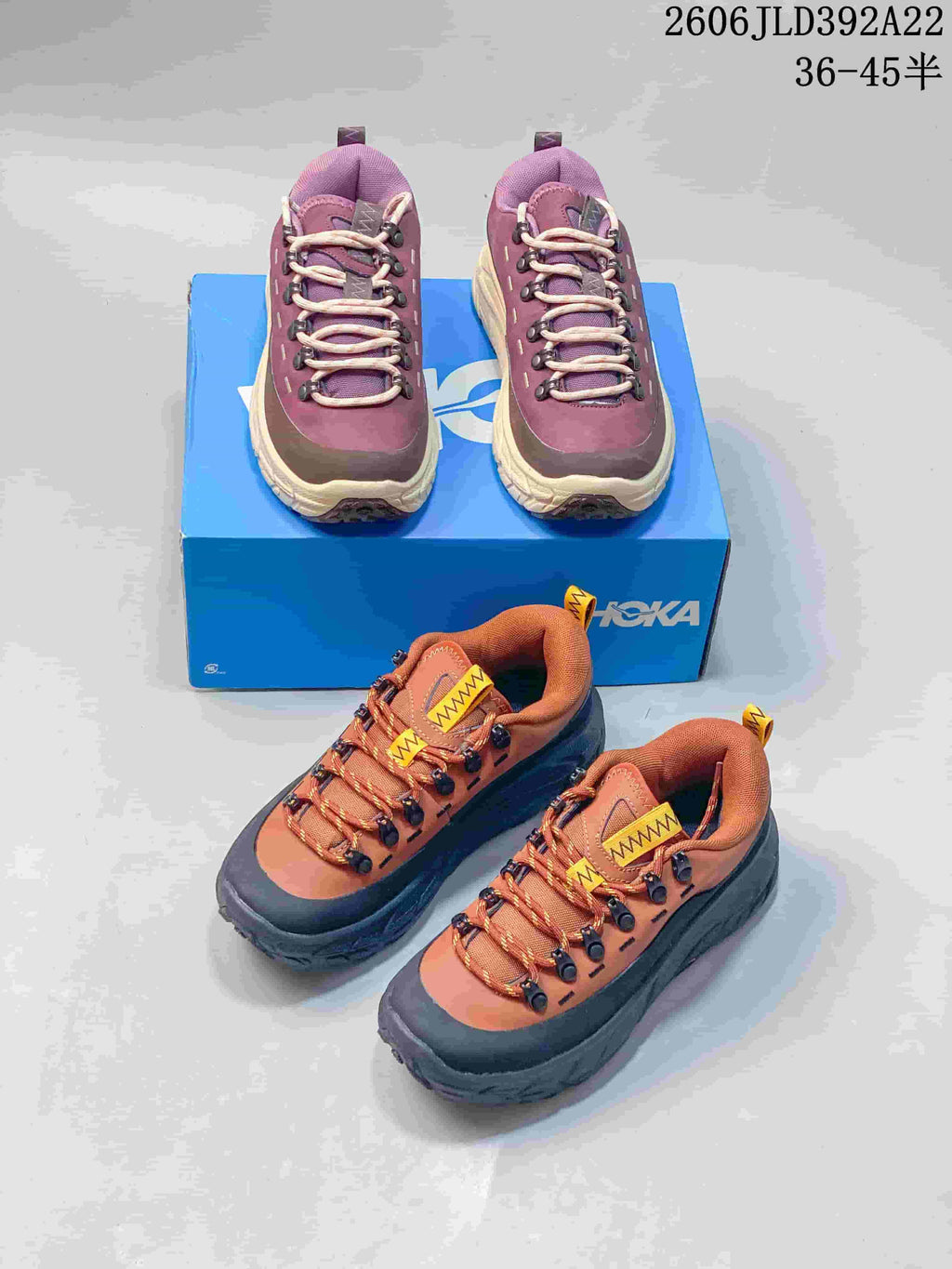 Plum and cream pair and rust orange and charcoal pair of HOKA low-top sneakers